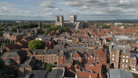 Establishing-Aerial-Drone-Shot-of-Old-Iconic-Roman-British-City-Centre-York-with-Red-Brick-Buildings-and-Famous-York-Minster-Cathedral-in-Background-North-Yorkshire-UK