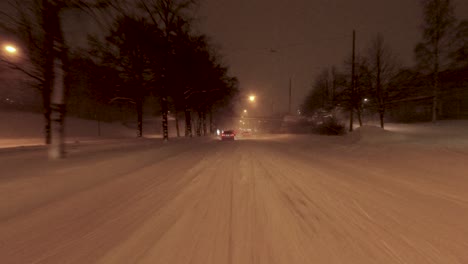 POV-shot-traveling-under-a-bridge-with-other-drivers-in-a-snow-covered-Helsinki