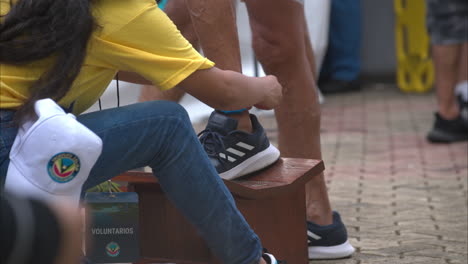 Slow-motion-close-up-of-a-marshall-taking-off-the-tag-on-a-male-competitors-ankle-at-the-end-of-a-triathlon