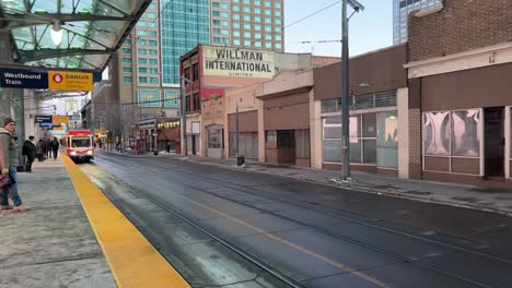 Calgary,-Alberta---December-14,-2022:-View-of-a-C-Train-pulling-up-at-a-commuter-train-platform-in-the-centre-of-Calgary,-Alberta-on-a-cold-winter-evening