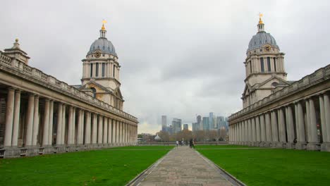 The-two-domed-towers-of-the-Old-Royal-Naval-College,-Greenwich,-London,-England-frame-a-cloud-on-a-summer-day