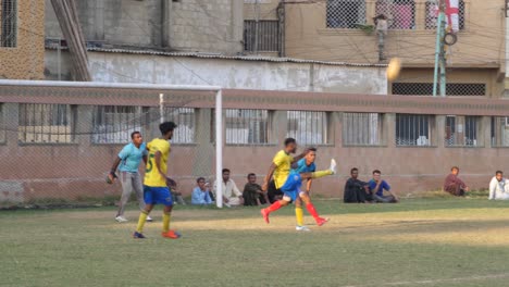 Close-shot-of-kids-playing-football-in-the-ground-of-Pakistan