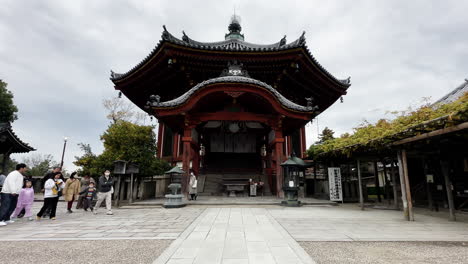 People-Praying-in-Buddhist-Temple,-Nara,-Japan,-Static-Shot