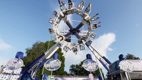 Crazy-swinging-adrenaline-frisbee-or-carousel-at-fairground-with-scared-people