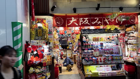 Cinematic-View-of-Small-Shops-With-Shopkeepers,-Side-Dolly,-Osaka,-Japan