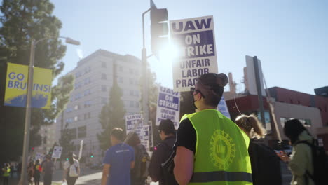 Young-Woman-Chants-into-a-Megaphone-on-a-Picket-Line-at-the-UC-Academic-Worker's-Strike-Picket-Line-in-UCLA-at-Golden-Hour