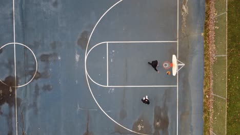 AERIAL:-Top-down-shot-of-a-basketball-game-at-the-park