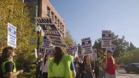 A-Strike-Leader-Holds-a-Picket-Sign-and-Addresses-a-Line-of-Striking-UC-Academic-Workers-on-UCLA's-Campus