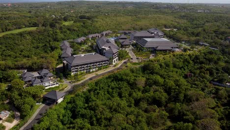 AERIAL:-Drone-shot-of-a-hotel-surrouned-with-lush-vegetation