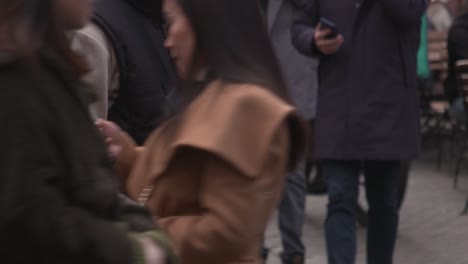 Man-with-satchel-bag-lost-in-a-crowd-of-people