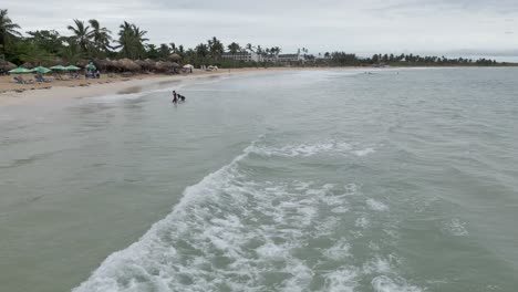 AERIAL:-Drone-shot-showing-people-enjoying-the-ocean-in-Dominican-republic