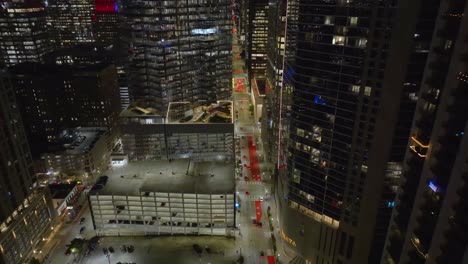 Aerial-view-of-traffic-in-middle-of-high-rise-in-Houston,-evening-in-Texas,-USA---reverse,-drone-shot