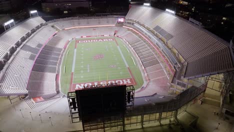 Aerial-view-around-the-illuminated-TDECU-Stadium,-night-in-Houston,-USA---orbit,-drone-shot