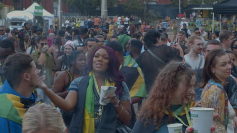 Crowd-of-people-dancing-and-partying-at-outdoor-music-festival,-England