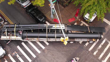 Top-Down-Aerial-View,-Truck-With-Long-Trailer-Carrying-Metal-Structure-Stuck-on-Street-Intersection-in-Manhattan,-New-York-USA