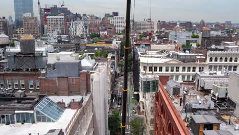 Aerial-View-of-Mercer-Street,-Manhattan-NYC-USA-and-Crane-Machine-Lifting-Up-New-AC-Units-on-Top-of-the-Building