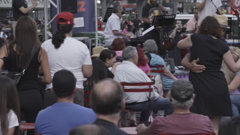 Static-shot-of-people-dancing-together-with-a-live-band-playing-in-the-background