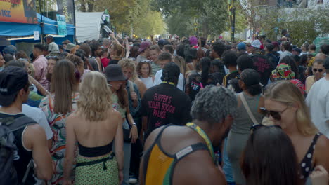 Crowds-and-group-of-people-having-street-party-and-parade-in-city