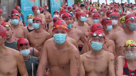 Swimming-enthusiasts-and-participants-wait-at-the-start-line-during-the-annual-swimming-competition-New-World-Harbour-Race-in-Hong-Kong