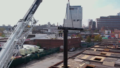 Aerial-View-of-Construction-Workers-in-Crane-Basket-Working-on-New-Billboard-Structure-60fps