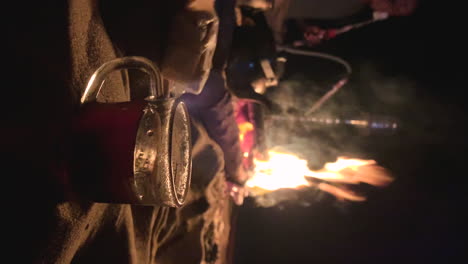 camping-in-Egypt-desert-preparing-tea-and-food-with-local-beduin-vertical-shot