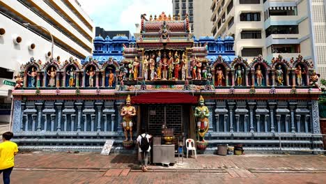 Person-Burning-Incense-Sticks-at-Hindu-Tempel,-Singapore