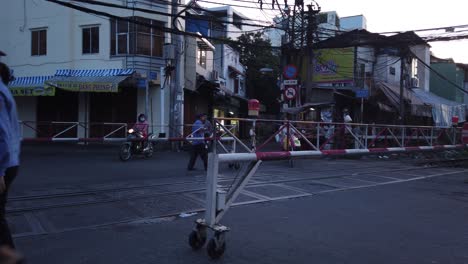 Early-morning-busy-street-being-closed-to-allow-a-train-to-pass