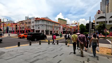 Behind-Group-of-Pedestrians-Cross-Street-in-Singapore-Downtown