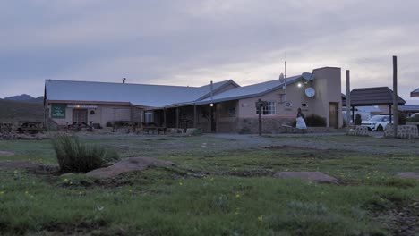 Staff-member-walks-to-door-at-mountain-lodge,-Sani-Pass,-Lesotho