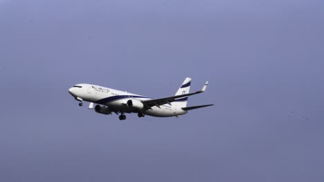 Israel-Airlines-aircraft-flying-against-cloudy-sky,-tracking-view