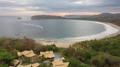 Playa-Carrillo-Beach-and-Hotel-Nammbu-with-half-moon-beach,-Aerial-flyover-shot