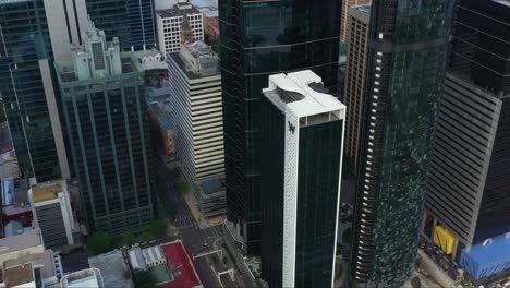 Aerial-fly-around-Brisbane-city-capturing-downtown-cityscape-featuring-transurban-corporate-office-tower,-w-hotel-and-the-one-residences-at-north-quay,-tilt-down-view-of-traffic-on-pacific-motorway