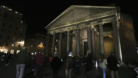 People-walk-outside-of-the-Pantheon-in-Rome,-Italy-at-night