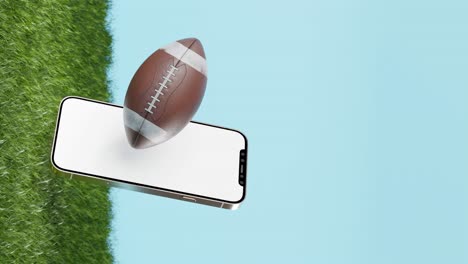 Ball-for-American-football-and-smartphone-blue-and-grass-background-and-copy-space