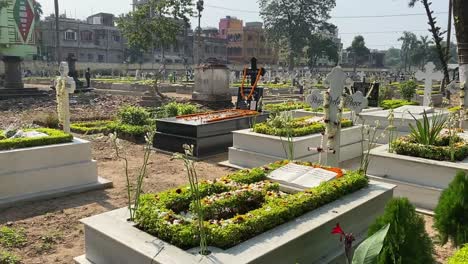 Close-up-shot-of-Cemetry-with-flowers-and-book-over-the-cemetry