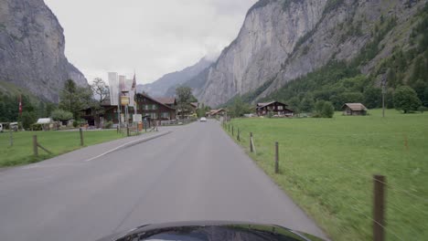 Driving-in-the-Lauterbrunnen-valley,-a-famous-travel-destination-in-Switzerland