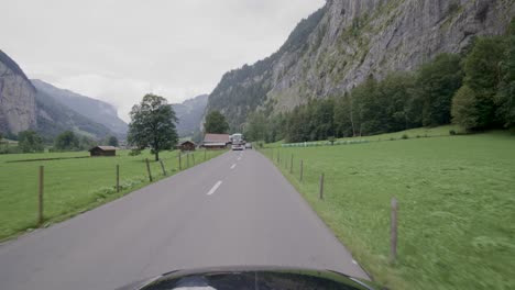 Driving-in-the-Lauterbrunnen-valley,-a-famous-travel-destination-in-Switzerland