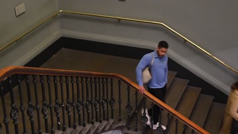 Going-down-the-stairs-within-Victoria-and-Albert-Museum,-London,-United-Kingdom