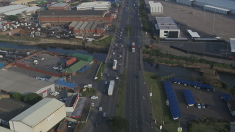 Drone-track-along-a-busy-road-in-Durban-through-an-industrial-area-following-trucks-and-cars