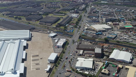 Wide-aerial-drone-shot-of-an-industrial-area-in-Durban-South-Africa-with-a-busy-intersection-in-the-distance