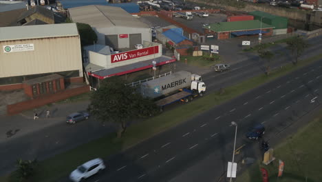 Drone-track-alongside-a-truck-carrying-a-shipping-container