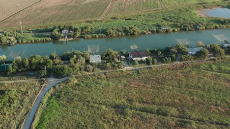 Aerial-view-of-fishing-huts-in-the-river,-Lido-di-Dante,-Fiumi-Uniti,-Ravenna-near-Comacchio-valley