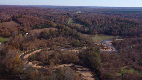 Curved-Creekbed-Amazing-And-Vibrant-Colors-Of-The-Forest-In-Autumn---aerial-shot