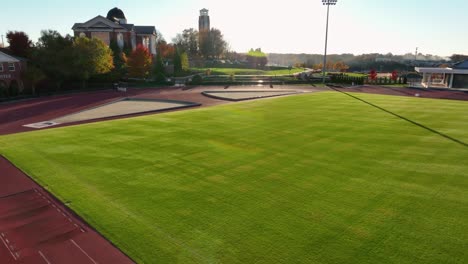 Aerial-of-track-and-field-outside-at-college-university-in-USA-during-golden-hour-light