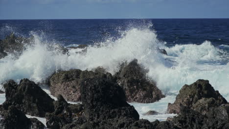 Waves-collide-with-rocky-rugged-shoreline-of-Madeira-Portugal,-slow-motion