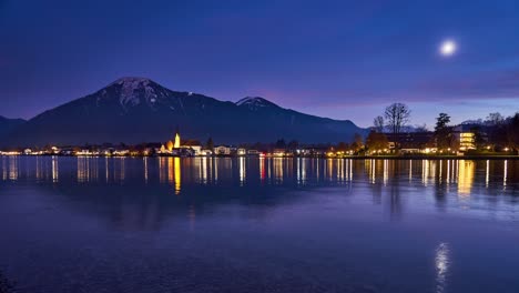 Night-timelapse-of-Tegernsee-with-snowcapped-mountains-in-the-background