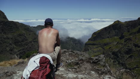 Hiker-takes-in-breathtaking-views-of-cloud-covered-Atlantic-Ocean,-Madeira