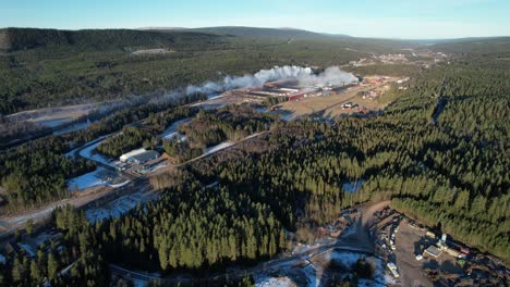 White-Smoke-Pollution-From-Industry-Over-Vast-Forest,-Aerial