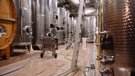 Massive-stainless-steel-wine-fermentation-tanks-in-modern-wine-cellar