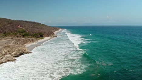 Birds-eye-view-wide-angle-over-beautiful-ocean-waves-at-seaside-in-Puerto-Vallarta